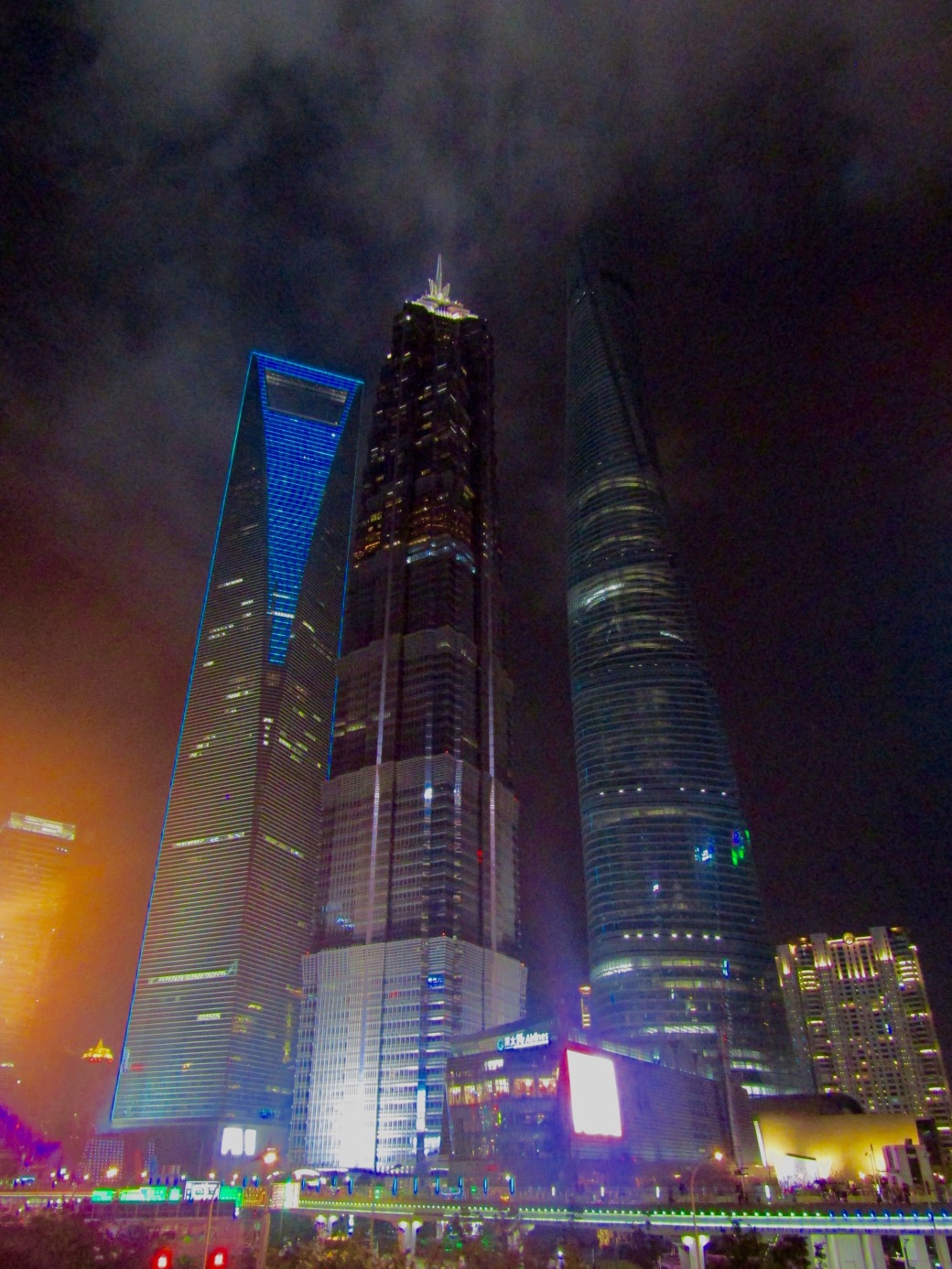 Three behemoths of the Shanghai Skyline. At left, the World Financial Center houses the world's second-highest hotel. In the center, Jin Mao Tower was once China's tallest building. At right, China's current champion is Shanghai Tower, the world's second-tallest building.