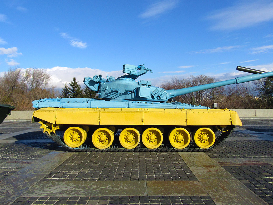 A military tank painted in the colors of Ukraine’s flag, blue and yellow. The blue represents the sky and the yellow, fertile fields of wheat.