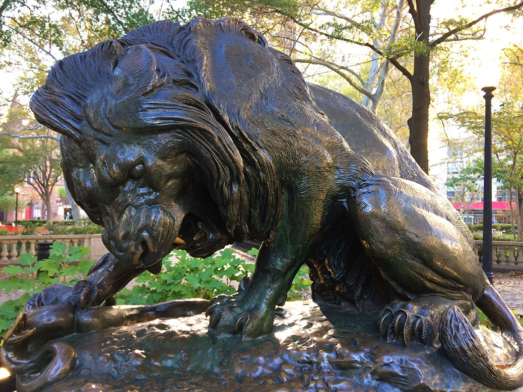 A statue of a lion squashing a snake in Rittenhouse Square, one of the original five public park spaces planned by William Penn in the late 1600s.